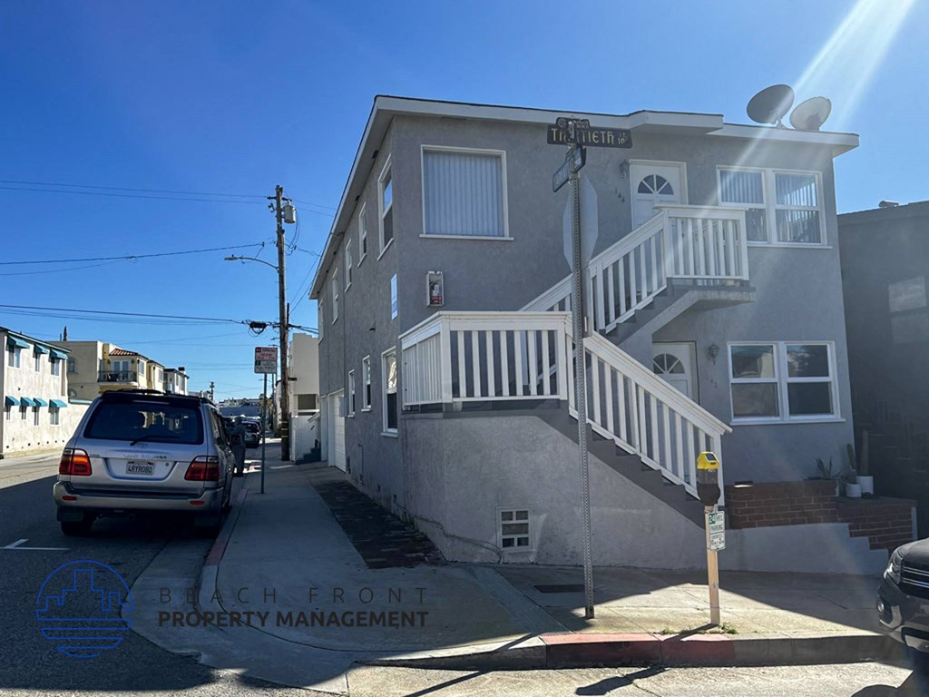 a city street with a car parked in front of a building