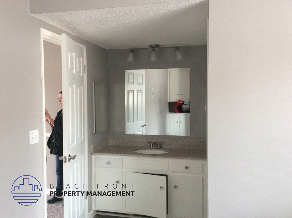 a bathroom with a sink and a mirror      and a door