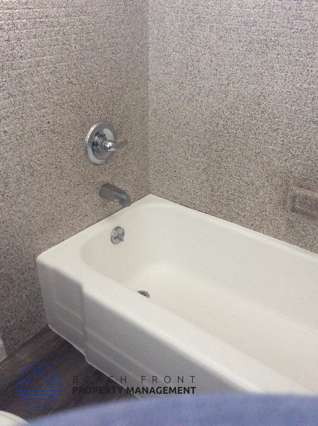 a bathroom with a white tub and a sink