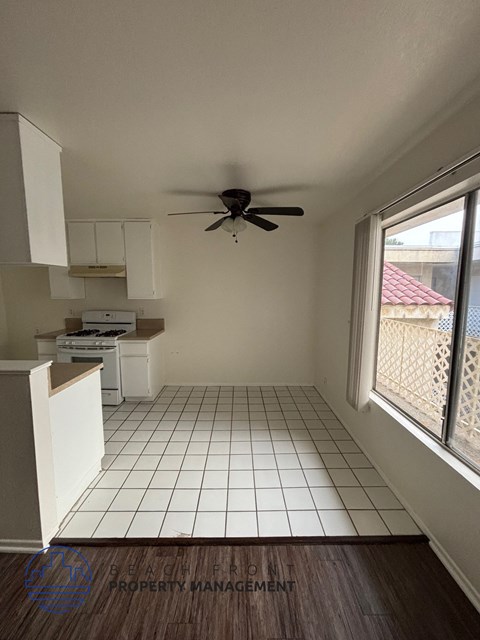 A room with a fan and a window.