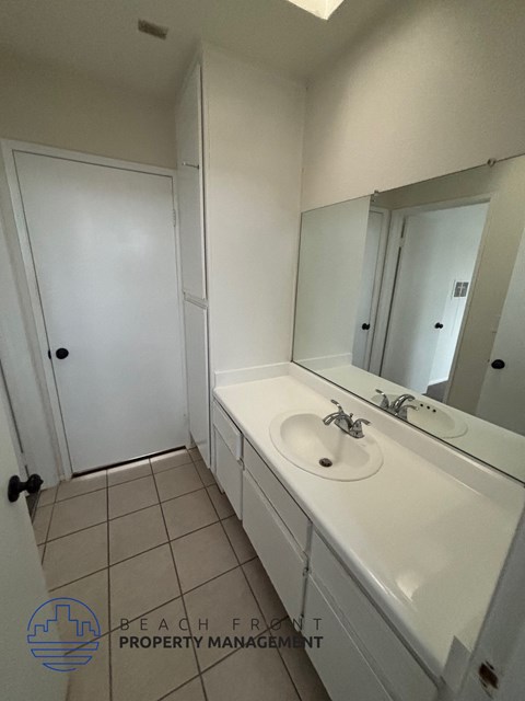 A bathroom with a sink, mirror, and toilet.