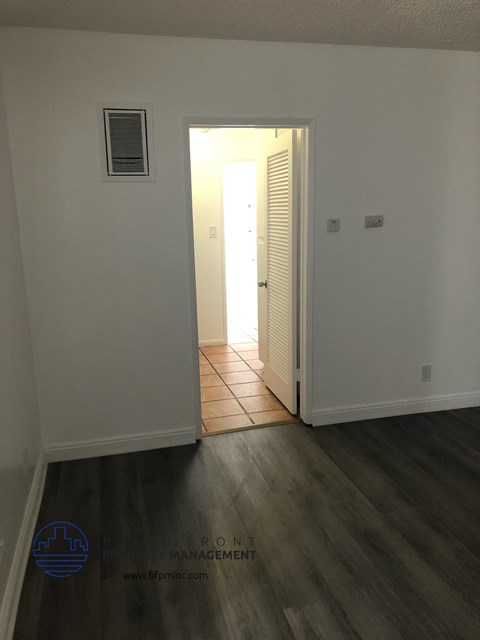 a room with white walls and a door to a hallway