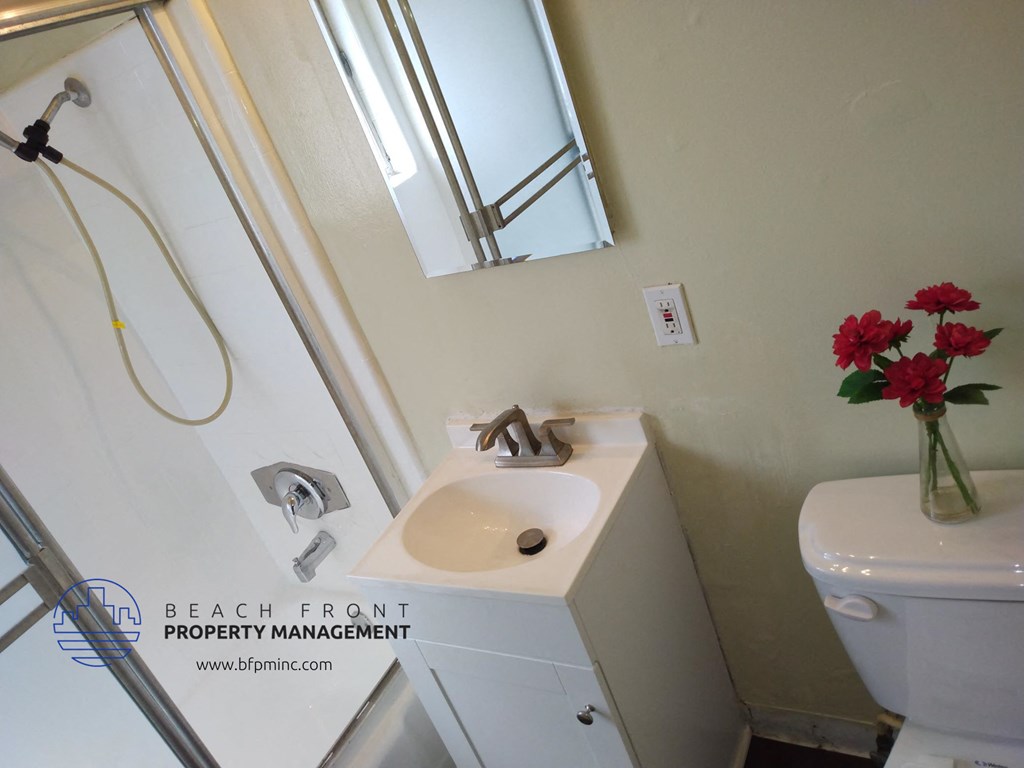 a small bathroom with a sink and a mirror and a toilet
