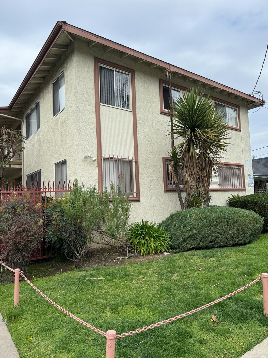 a white house with a palm tree in front of it