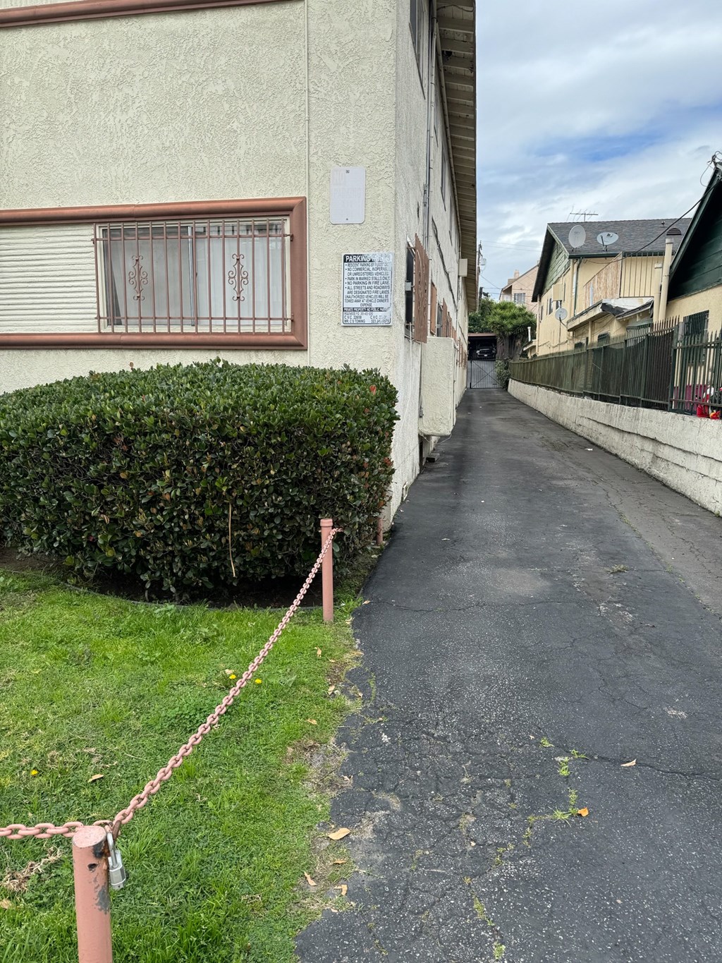 the sidewalk in front of a house is blocked off with a chain