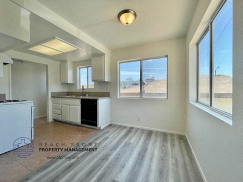 a kitchen with a large window and a sink and a counter