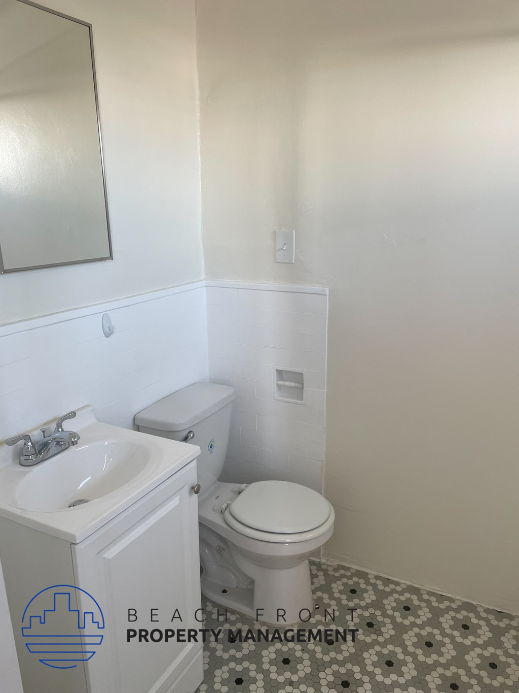 a white bathroom with a toilet and a sink
