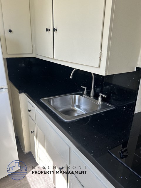 A kitchen with a sink and cabinets.