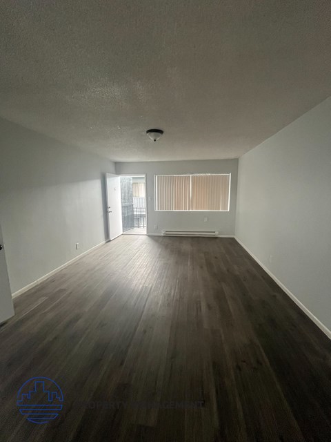 A room with wooden floors and white walls.