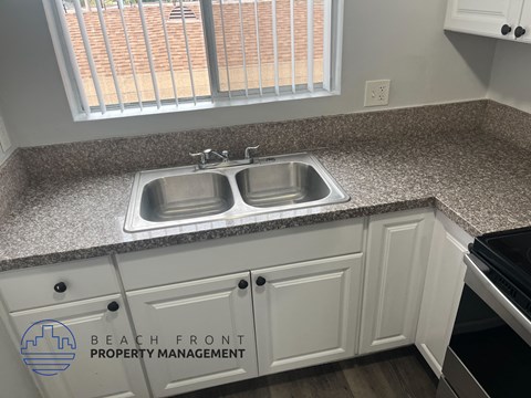 A kitchen with a sink and cabinets.