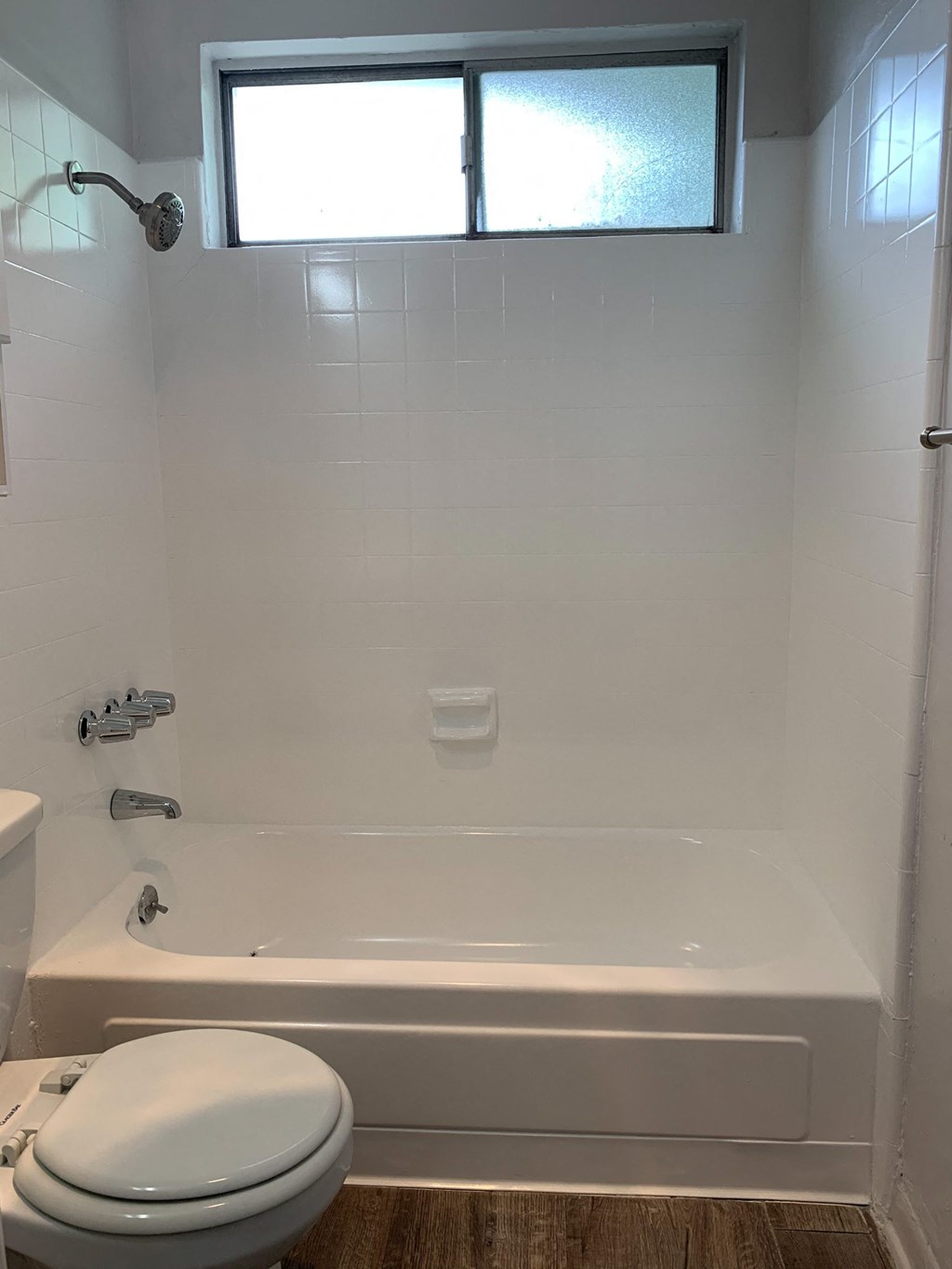 a small bathroom with a tub and a toilet