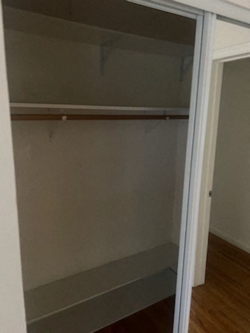 a walk in closet with a sliding glass door