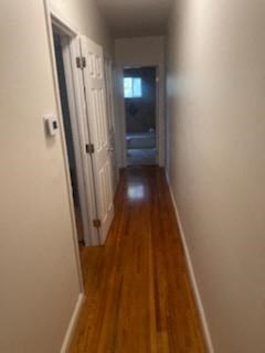 a hallway with wooden floors and a door