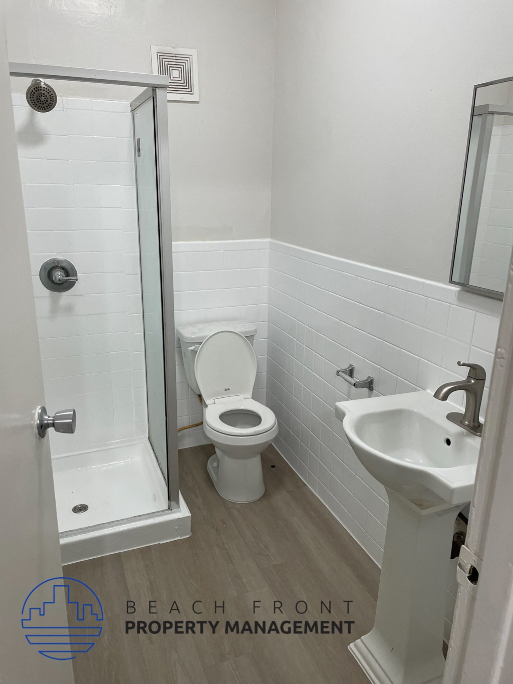 a small bathroom with a shower toilet and sink