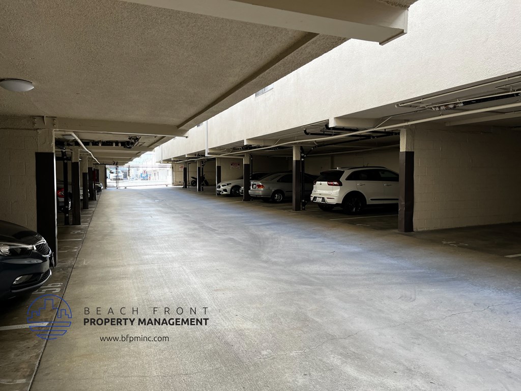 an empty parking garage with cars parked in it