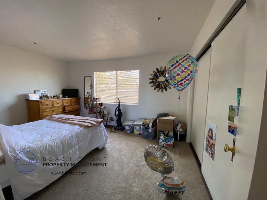 a bedroom with a bed and a balloon in the corner