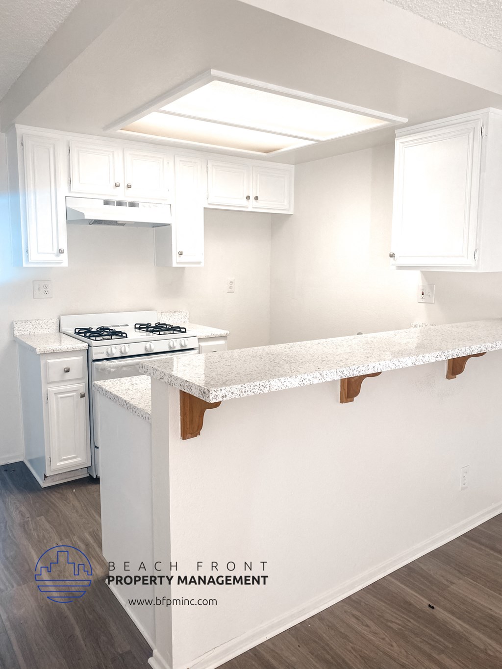 a white kitchen with white cabinets and white counter tops and a white stove top oven