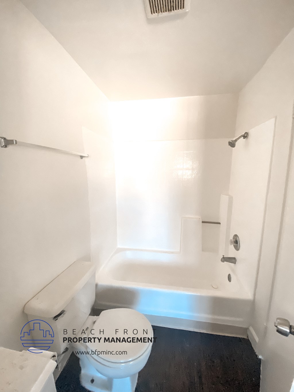 a small bathroom with a toilet and a bath tub