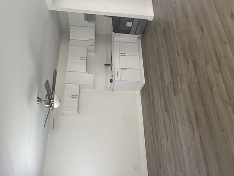 an overhead view of a living room with white walls and wooden floors