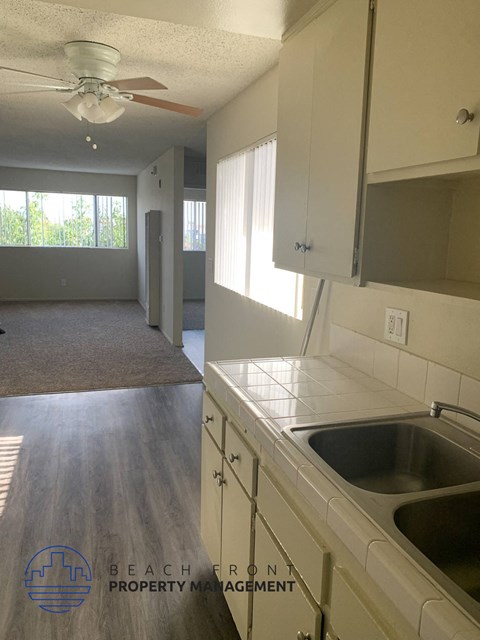 A kitchen with a sink and a fan.