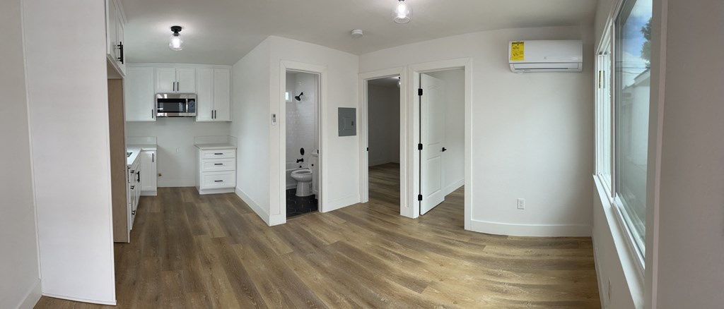 a bedroom with a medium sized bed and a window