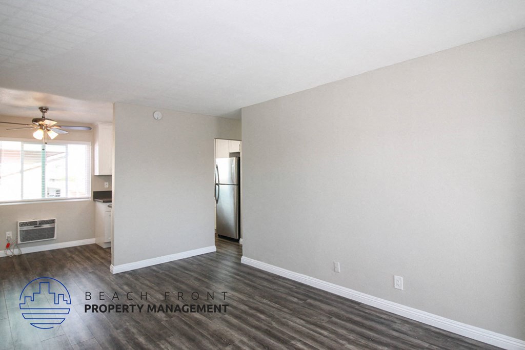 the living room and kitchen of an empty apartment