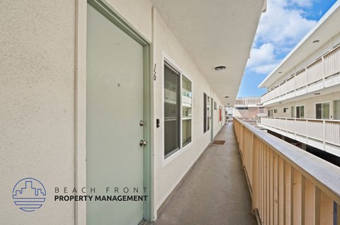 A balcony with a view of the sky and buildings.