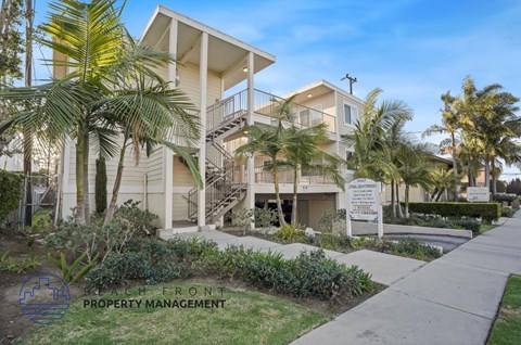 A building with a sign that says "South Front Property Management" in front of it.