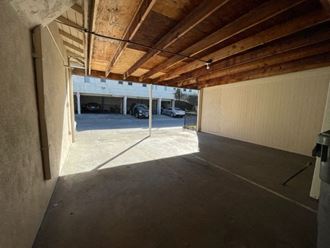 a garage with wooden ceilings and a parking lot