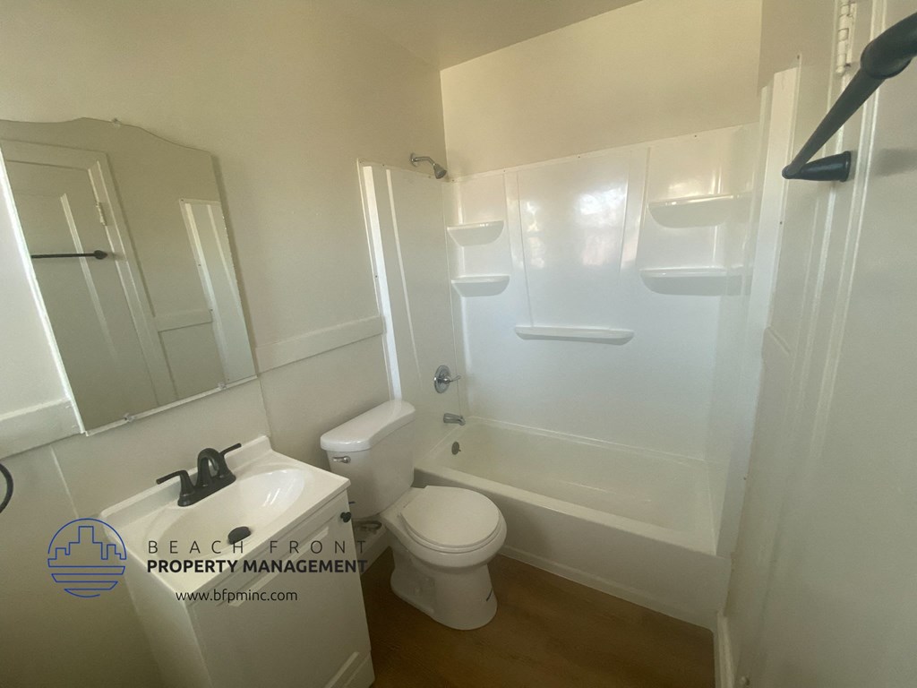 a small bathroom with a toilet and a sink and a tub