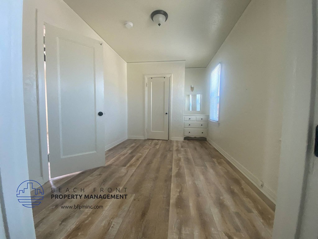 the master bedroom has a large walk in closet and hardwood flooring