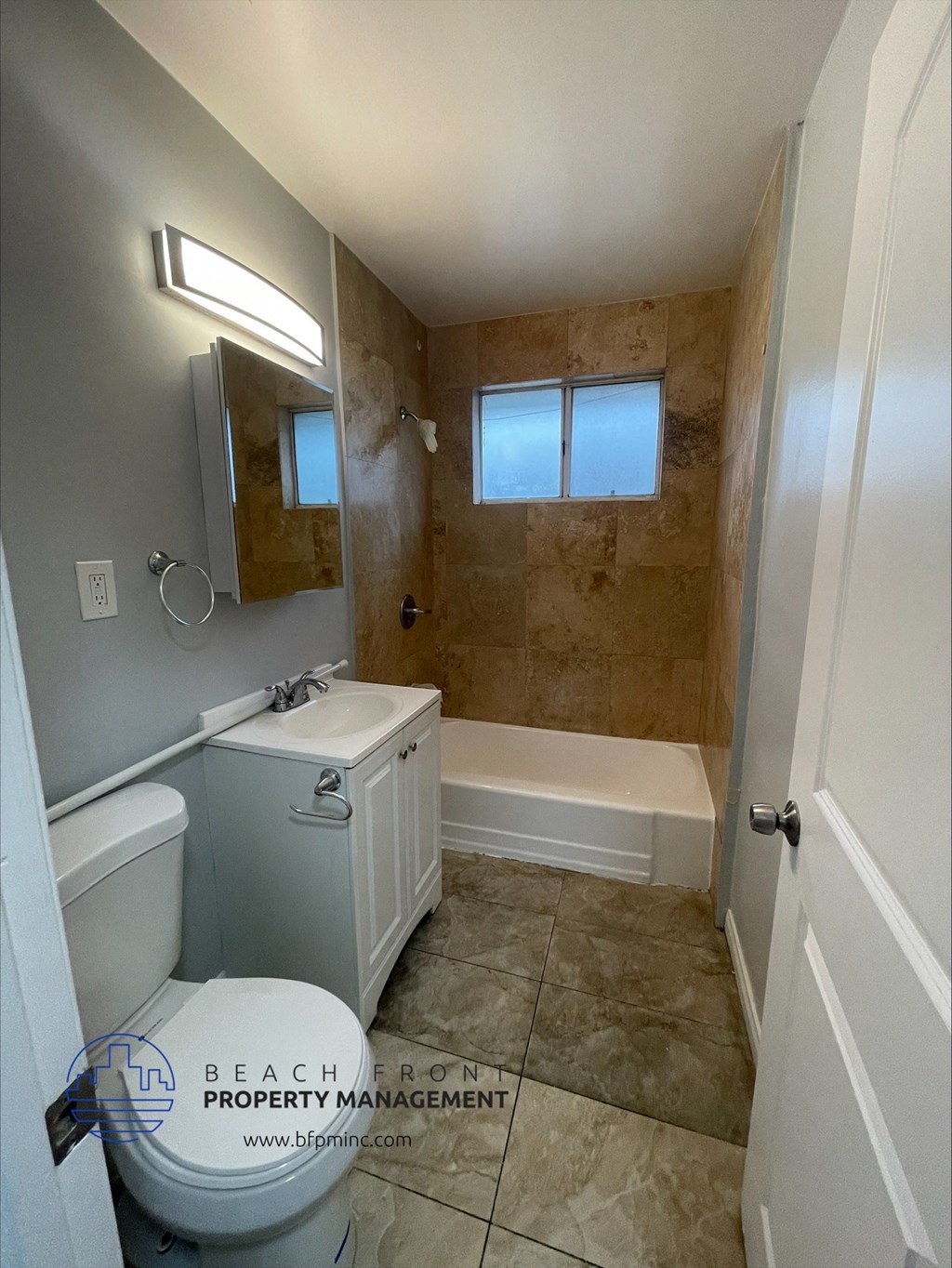 the interior of a bathroom with a toilet sink and bathtub