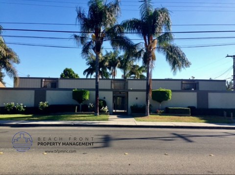 a building with palm trees in front of it