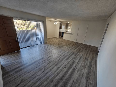 an empty living room with a sliding glass door