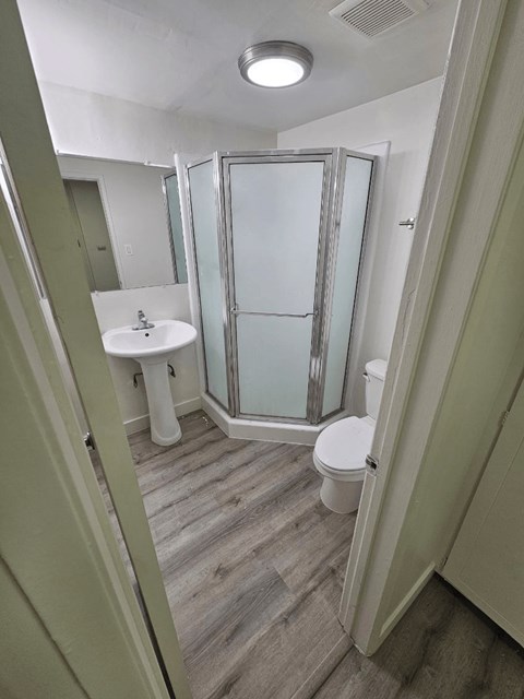 a bathroom with a toilet sink and shower