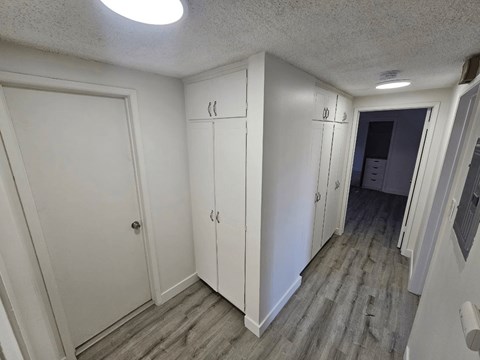 an empty room with white walls and a wooden floor