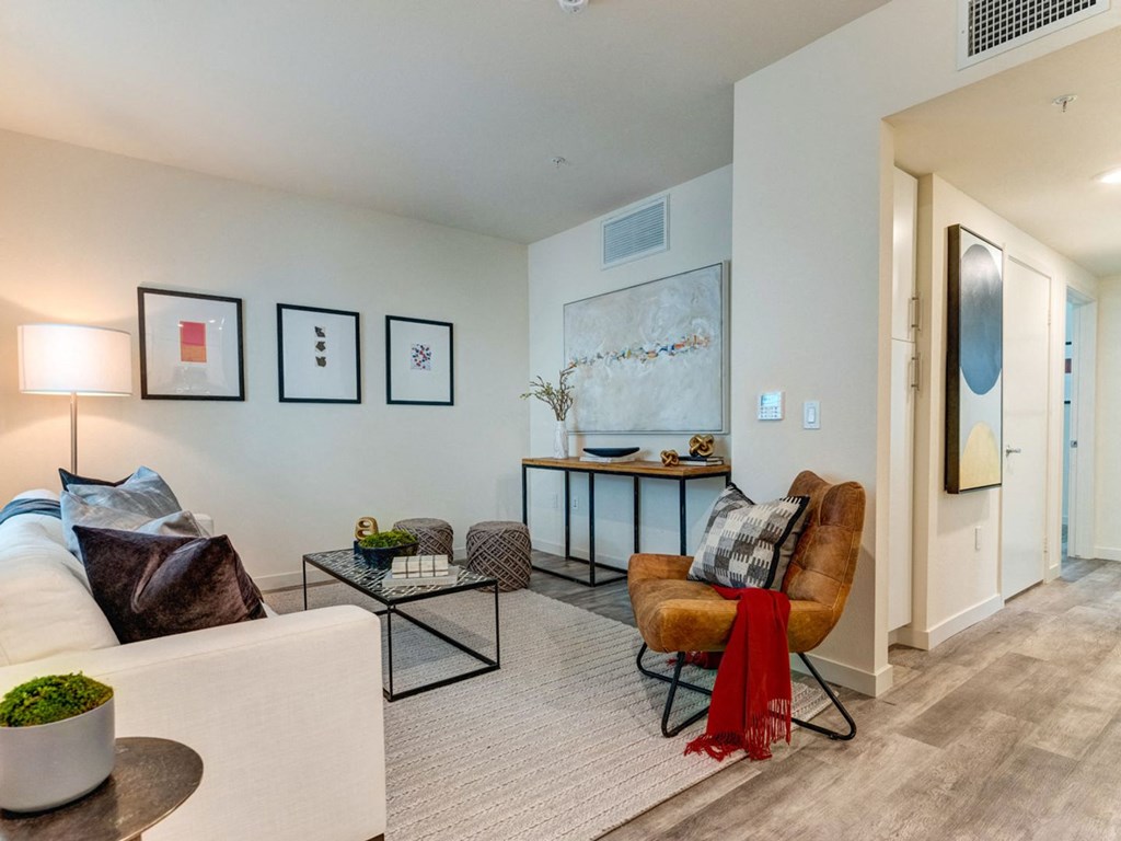 a living room with a couch and a chair and a table