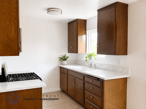 A kitchen with wooden cabinets and a white countertop.