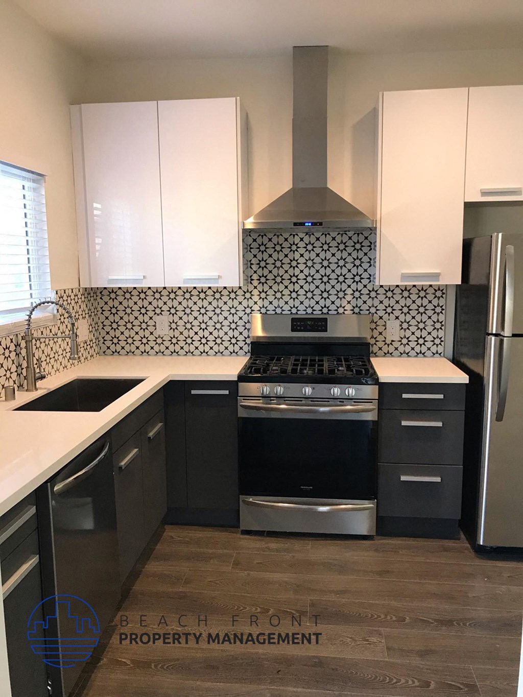 a kitchen with black and white cabinets and a stove