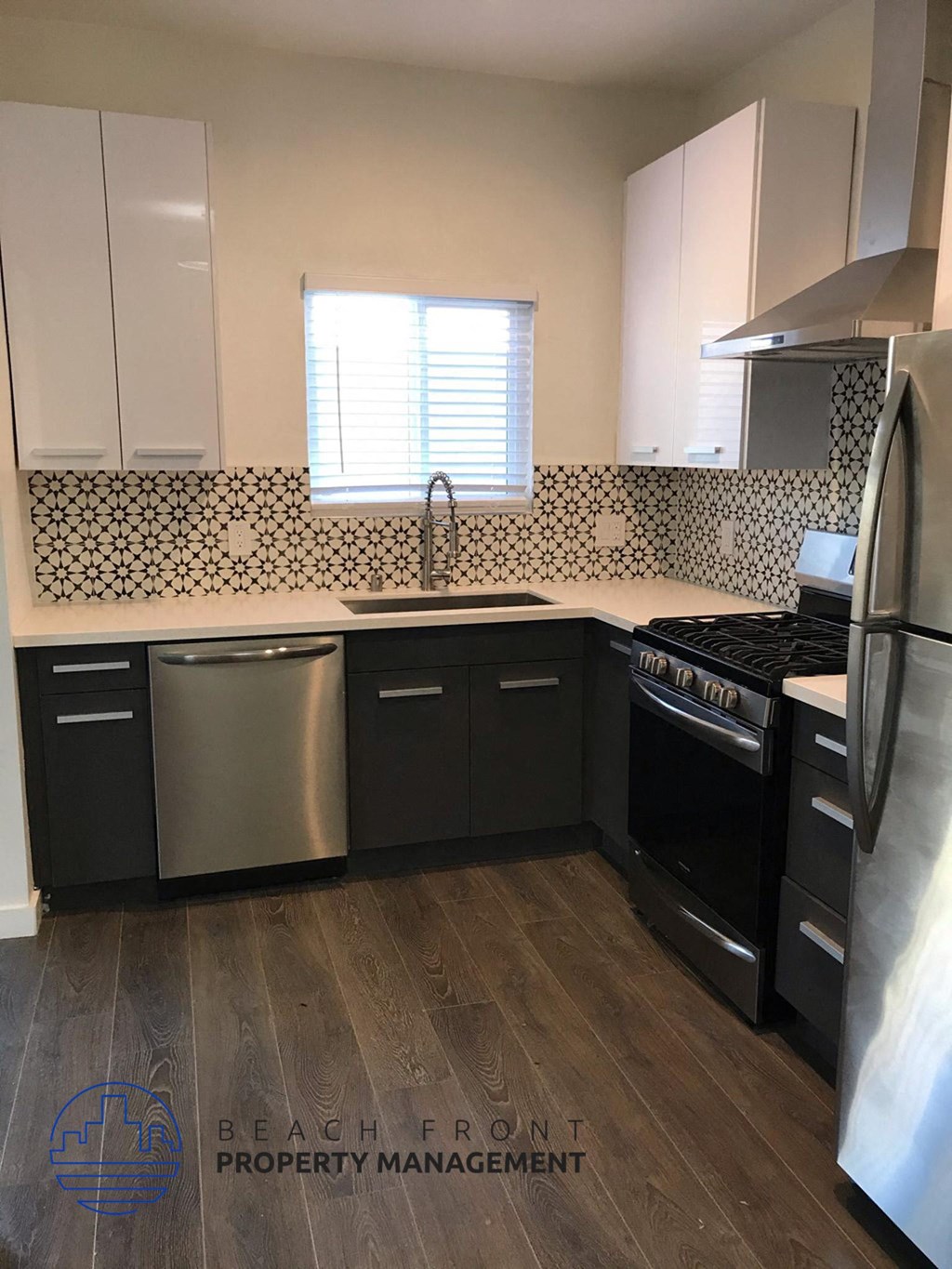 a kitchen with black appliances and white cabinets