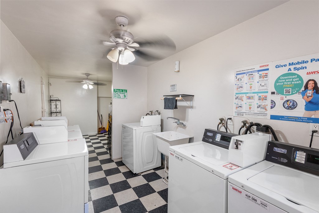 a laundry room with washing machines and a ceiling fan