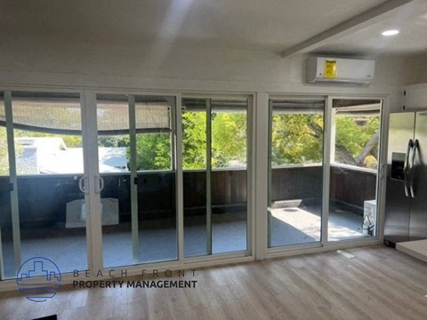 a living room with sliding glass doors and a wood floor