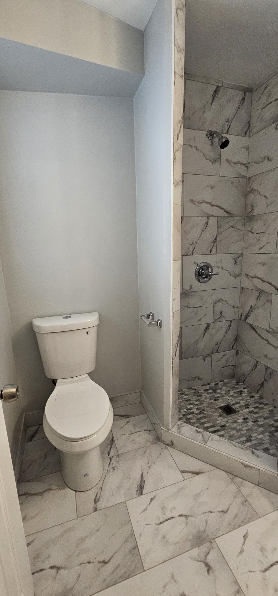 a small bathroom with a toilet and a shower