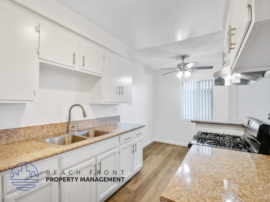 A kitchen with a countertop and a stove top oven.
