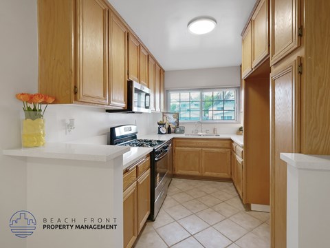 A kitchen with wooden cabinets and a white countertop.