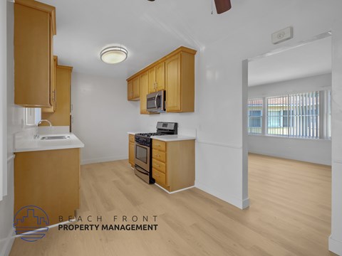 A kitchen with wooden cabinets and a white countertop.