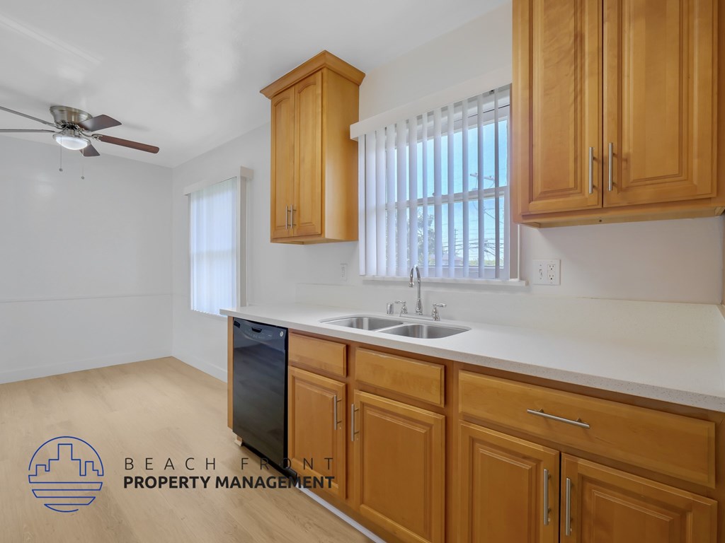 A kitchen with wooden cabinets and a white countertop.