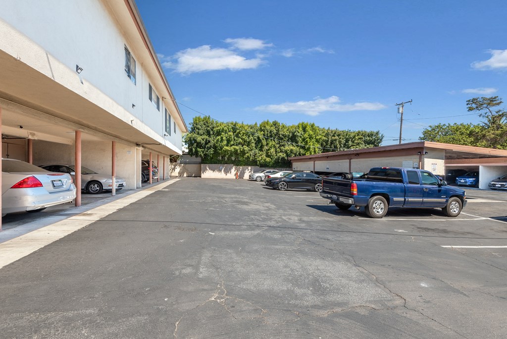 a parking lot with cars parked in front of a building