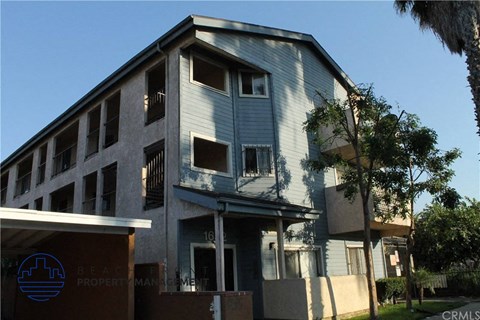 a blue and white building with a tree in front of it