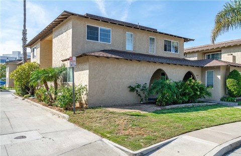 a house with a yard and a sidewalk in front of it